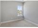 Bright bedroom with neutral walls, carpet, and a window overlooking an outside street with a house in view at 341 Trailmore Ln, Summerville, SC 29486