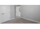 Bedroom showcasing neutral walls, carpet, and a closet, with an open doorway offering a view to the hallway at 341 Trailmore Ln, Summerville, SC 29486