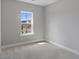 Bright bedroom featuring neutral walls, carpet, white trim, and a window providing natural light at 341 Trailmore Ln, Summerville, SC 29486