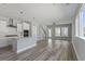 Open-concept living space with modern kitchen featuring stainless steel appliances and bright airy living room, creating a seamless flow at 341 Trailmore Ln, Summerville, SC 29486