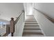 White staircase with wood handrail leads to the upper level of the home at 341 Trailmore Ln, Summerville, SC 29486