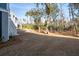 Beautiful home featuring large backyard with wooded border adjacent to a deck and stairs at 7038 Elm Tree Ln, Johns Island, SC 29455