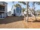 Two-story home with a charming blue exterior, ample backyard space, and mature trees at 7038 Elm Tree Ln, Johns Island, SC 29455