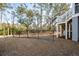 Home featuring backyard with black metal fence adjacent to mature trees at 7038 Elm Tree Ln, Johns Island, SC 29455