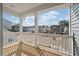 Balcony view shows a wooden deck with white railing and neighborhood street with new construction homes at 7038 Elm Tree Ln, Johns Island, SC 29455