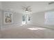 Spacious, neutral bedroom with three windows, ceiling fan and plush carpeting offers comfortable living space at 7038 Elm Tree Ln, Johns Island, SC 29455