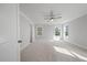 Bright, neutral bedroom with three windows, ceiling fan and plush carpeting offers comfortable living space at 7038 Elm Tree Ln, Johns Island, SC 29455