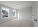 Well-lit, neutral bedroom with two windows and plush carpeting offers a comfortable and versatile living space at 7038 Elm Tree Ln, Johns Island, SC 29455