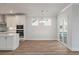 Open dining area with wood floors, a chandelier, and sliding glass doors to the outdoor deck at 7038 Elm Tree Ln, Johns Island, SC 29455