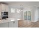 Bright kitchen features quartz countertops, stainless appliances, and sliding glass doors to the outdoor deck at 7038 Elm Tree Ln, Johns Island, SC 29455