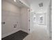 Well-lit laundry room area with black tile flooring and a large rack for storage at 7038 Elm Tree Ln, Johns Island, SC 29455