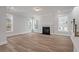 Spacious living room featuring a fireplace, wood-look flooring, and multiple windows at 7038 Elm Tree Ln, Johns Island, SC 29455