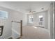 Second-floor loft featuring neutral carpet, a ceiling fan, and access to the balcony at 7038 Elm Tree Ln, Johns Island, SC 29455