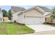 Exterior shot of a two-car garage with a white door and landscaping at 123 Cantona Dr, Summerville, SC 29483
