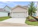 Exterior shot of a two-car garage with a white door and landscaping at 123 Cantona Dr, Summerville, SC 29483