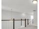 Upstairs hallway with dark and white railing, light fixture and view of a window at 123 Cantona Dr, Summerville, SC 29483