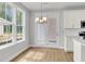 Bright eat-in kitchen area with large windows, wood flooring and modern lighting fixture at 123 Cantona Dr, Summerville, SC 29483