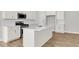 Bright kitchen features stainless steel appliances, white cabinets, white backsplash, and a large center island at 123 Cantona Dr, Summerville, SC 29483