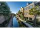 Scenic view of canal with sidewalks and beautiful Charleston-style homes featuring balconies and palm trees at 55 Rialto Rd, Mount Pleasant, SC 29464