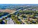An aerial view shows a neighborhood with mature trees, pool, and a scenic waterfront at 1647 Sulgrave Rd, Charleston, SC 29414