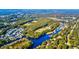 A high angle aerial shot reveals a community nestled along a river with ball fields and lush trees at 1647 Sulgrave Rd, Charleston, SC 29414