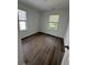 Bedroom with two windows providing natural light and hardwood floors at 1832 Helm Ave, North Charleston, SC 29405