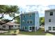 Three-story home with a blue exterior, fenced yard, and mature trees at 1832 Helm Ave, North Charleston, SC 29405