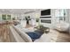 Open-concept living room with fireplace, modern decor, and a view of the eat-in kitchen at 1832 Helm Ave, North Charleston, SC 29405