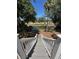 Staircase leading to backyard with view of pond surrounded by lush trees and greenery at 21 Twin Oaks (1/8 Share) Ln, Isle of Palms, SC 29451
