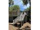 Rear exterior view of home with stairs leading to second level deck at 21 Twin Oaks (1/8 Share) Ln, Isle of Palms, SC 29451