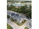 An aerial view showcases a lakeside neighborhood with charming homes and lush greenery at 1751 Bee Balm Rd Rd, Johns Island, SC 29455
