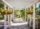 White pergola walkway with hanging flower baskets and benches at 1848 Nola Run, Summerville, SC 29485