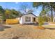 Charming ranch home with white brick exterior, landscaping, and wooden fence at 1609 Oxford St, Charleston, SC 29407