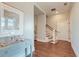 Elegant hallway with hardwood floors and a curved staircase at 169 Cooper River Dr, Mount Pleasant, SC 29464
