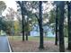 Two-story white house with a two-car garage, and a tree-lined street at 5629 Ellington School Rd, Ravenel, SC 29470