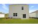 The home exterior features a sliding glass door and a well-kept lawn in this spacious backyard at 6261 Gritman Dr, Hollywood, SC 29470