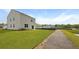 The backyard view showcases new construction with fresh landscaping and a walking path at 6261 Gritman Dr, Hollywood, SC 29470