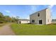 A spacious backyard shows a well-maintained lawn with a view of the home's exterior and a detached garage at 6261 Gritman Dr, Hollywood, SC 29470