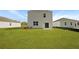 This backyard shows an ample lawn with mulch beds and a view of the home's rear exterior at 6261 Gritman Dr, Hollywood, SC 29470