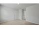 A clean, carpeted bedroom with white walls and doors leading to a closet and hall at 6261 Gritman Dr, Hollywood, SC 29470