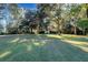 A charming house with a spacious front yard, mature trees, and inviting curb appeal at 4415 Lord Proprietors Rd, Hollywood, SC 29449