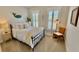 Bright bedroom features a cozy bed with plush bedding, complemented by natural light and stylish decor for a tranquil ambiance at 3105 Sturbridge Rd, Mount Pleasant, SC 29466