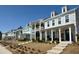 Charming two-story townhomes with covered front porches and manicured landscaping create a welcoming community atmosphere at 3105 Sturbridge Rd, Mount Pleasant, SC 29466