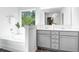 Bright bathroom features dual sink vanity, soaking tub and window with treed view at 185 Surf Bird Rd # 506P, Summerville, SC 29486