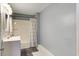 Bathroom featuring a shower-tub combo, a white vanity, and blue-grey walls at 118 Carter, Walterboro, SC 29488