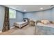 Bedroom featuring twin beds, carpet floors, light blue walls, and a large window at 118 Carter, Walterboro, SC 29488
