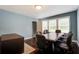 Office featuring a table, office chairs, hardwood floors, light blue walls, and large windows at 118 Carter, Walterboro, SC 29488