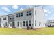 Exterior shot of a home's backyard and lawn, showcasing well-maintained landscaping and home design at 569 Trotters Ln # 222, Moncks Corner, SC 29461