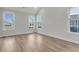 Bright bedroom with neutral walls, wood-look floors, and multiple windows at 709 Maynard Ln, Summerville, SC 29486