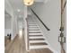 Bright foyer with hardwood floors, white trim, and a staircase leading to the second floor at 709 Maynard Ln, Summerville, SC 29486